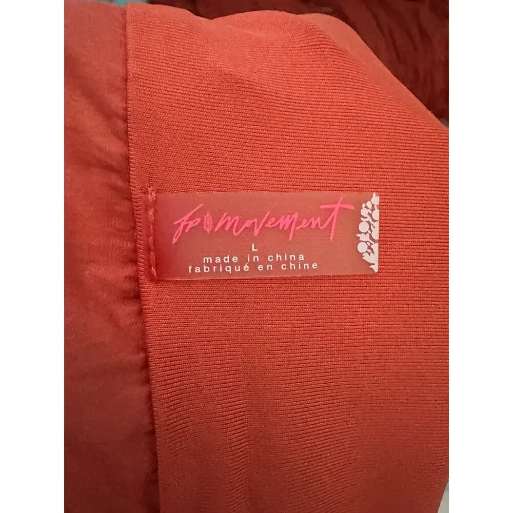 Free People FP Movement Way Home shorts in a vibrant coral reddish-orange color